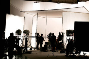 Silhouette of a production in progress on a white stage.